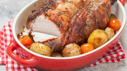 63569168 - boneless pork loin roast with potatoes and tomatoes