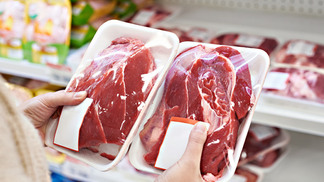 Buyer hands with beef meat packages at the grocery store