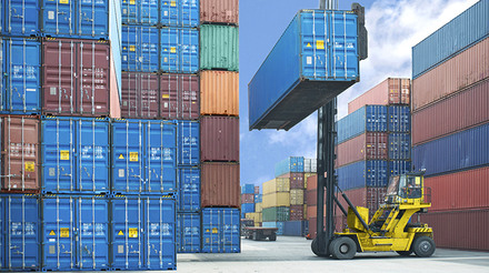 forklift handling container box loading to truck in import export logistic zone